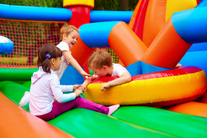 kids having fun on inflatable attraction playground